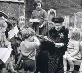 Maria Montessori with a group of children.